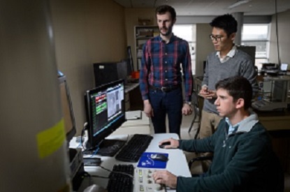 Graduate students working on computer